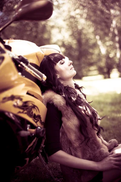  woman  sitting near her motorcycle. — Stok fotoğraf